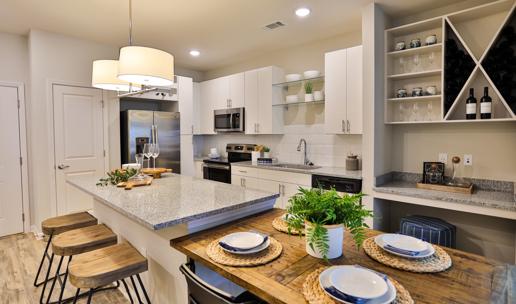 stunning kitchen at Capital Club Apartments featuring wine rack and stainless appliances