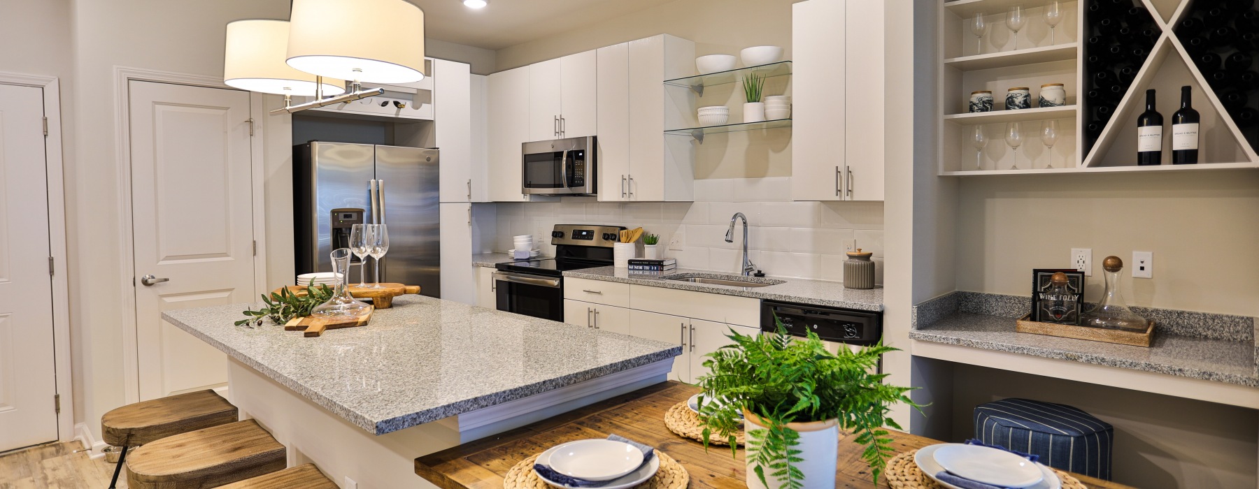 stunning kitchen at Capital Club Apartments featuring wine rack and stainless appliances